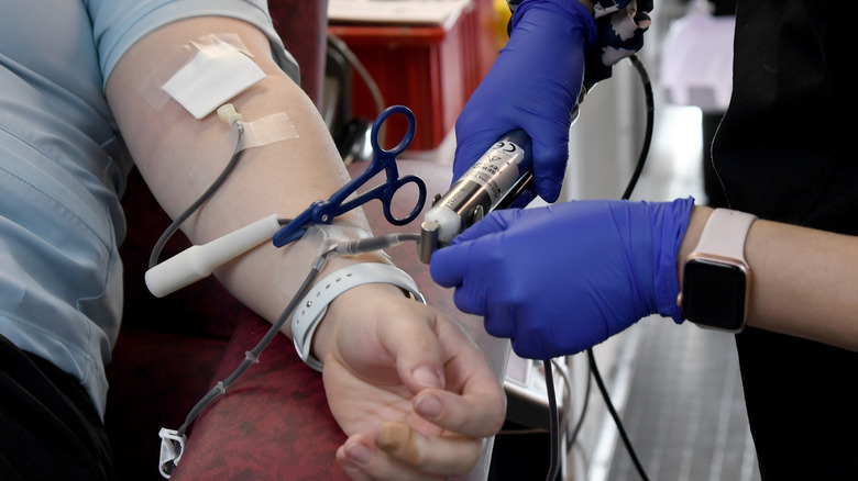 Medical provider setting up a blood donor