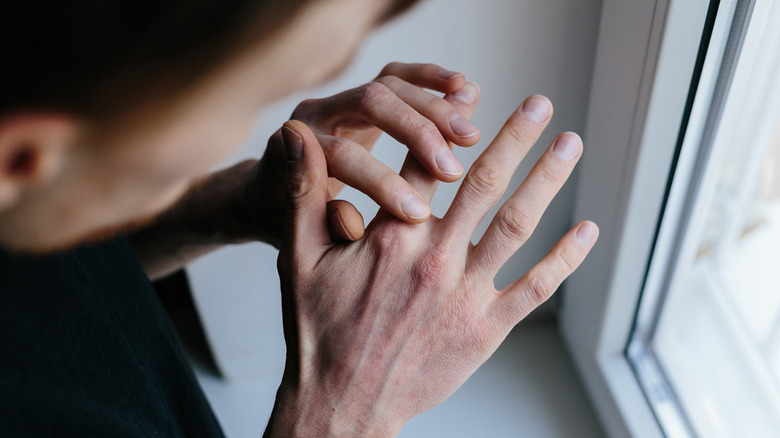 man looking at his hand