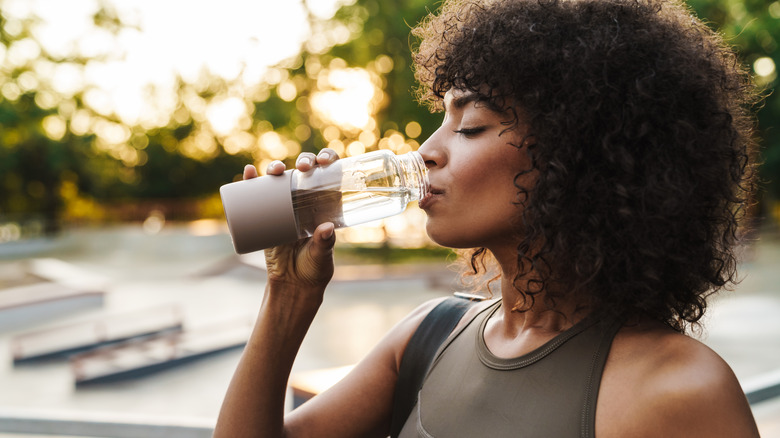 Woman exercising and drinking water