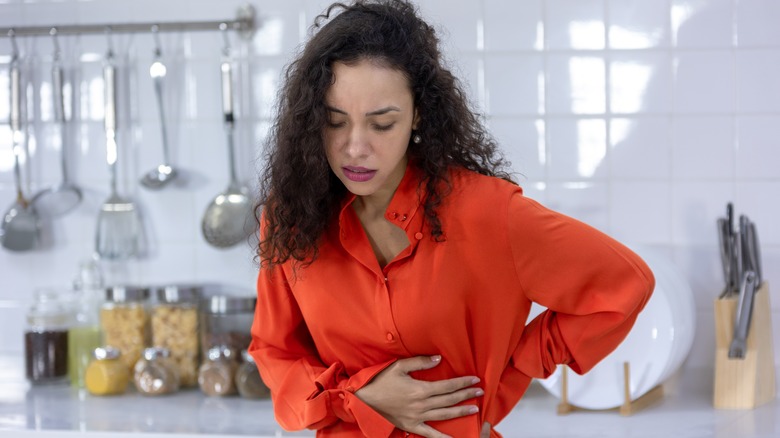 Nauseous woman touching stomach