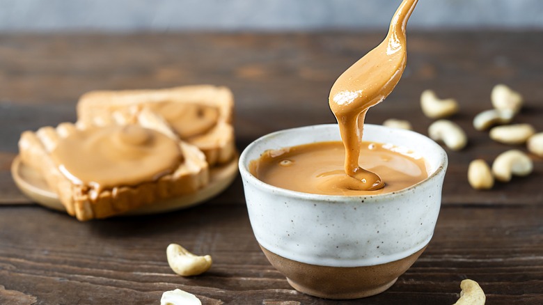 Cup of peanut butter and toast slices