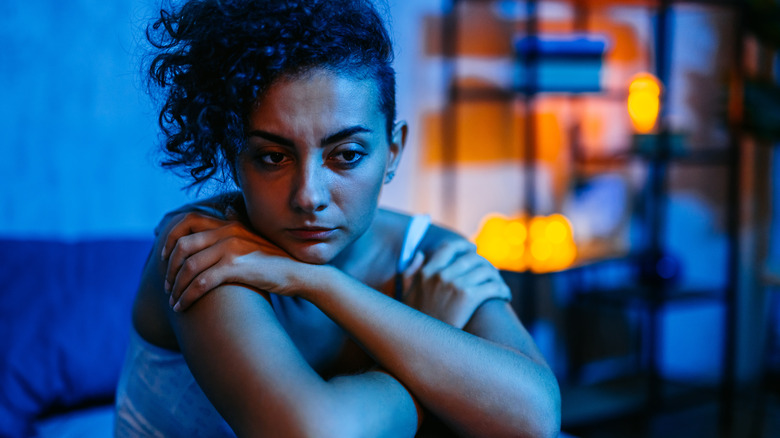 Worried person sitting in bed