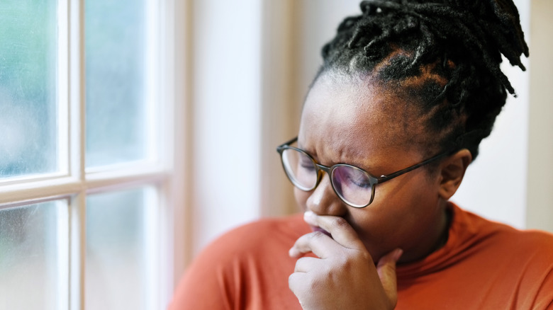 Sad woman covering mouth