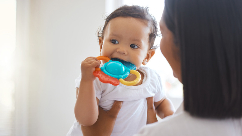 Parent holding teething child