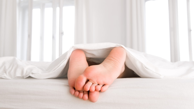Rubbing feet together under bedsheets
