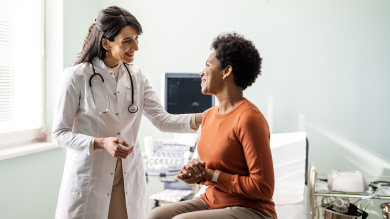 woman being reassured by her doctor