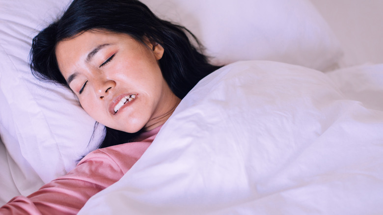 Woman grinding teeth at night