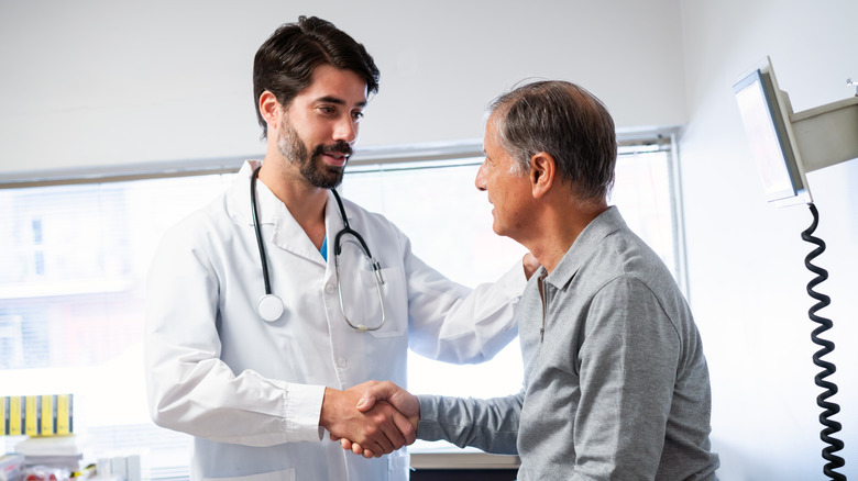 older man shaking hands with his doctor