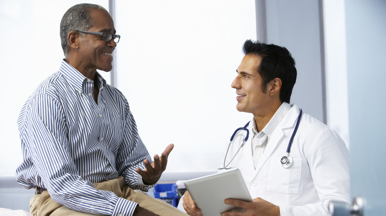 Man speaking to doctor