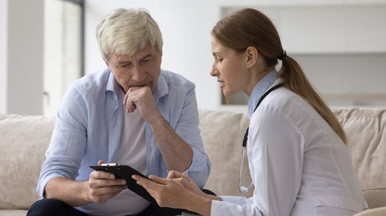 A female doctor giving a male patient his results