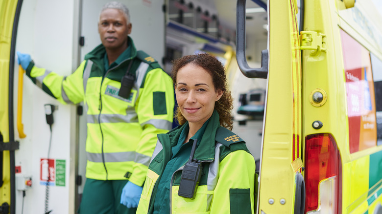 two EMTs standing in the back of an ambulance