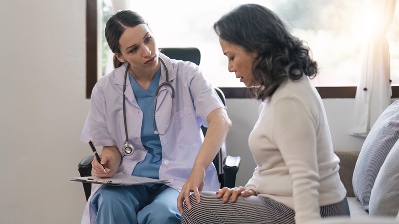 Doctor examining patient's knee