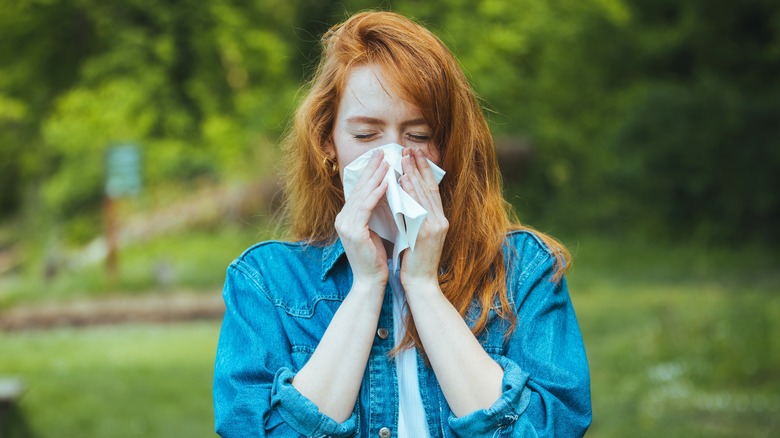 Person blowing nose