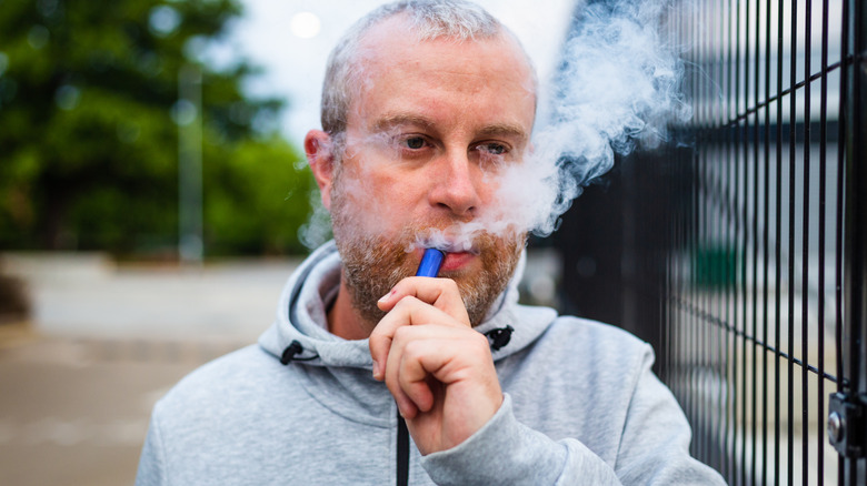 Individual vaping outdoors