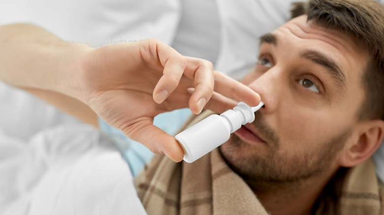 Man using a nasal spray