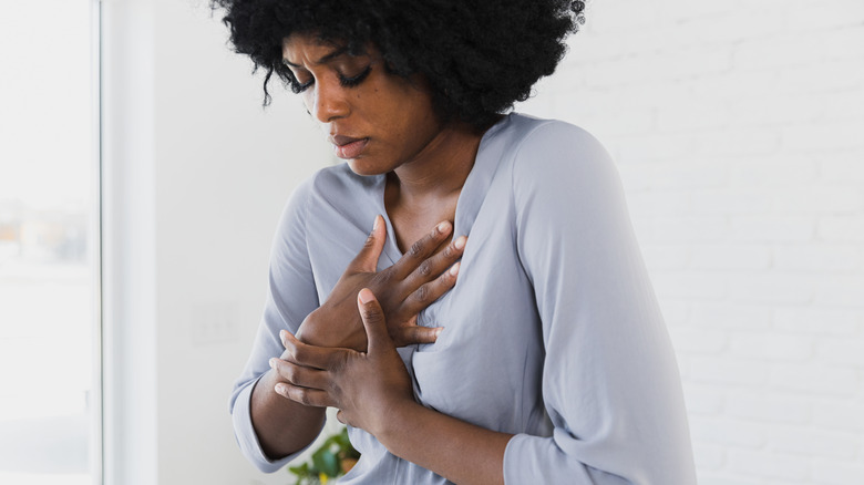 Woman experiencing heart burn