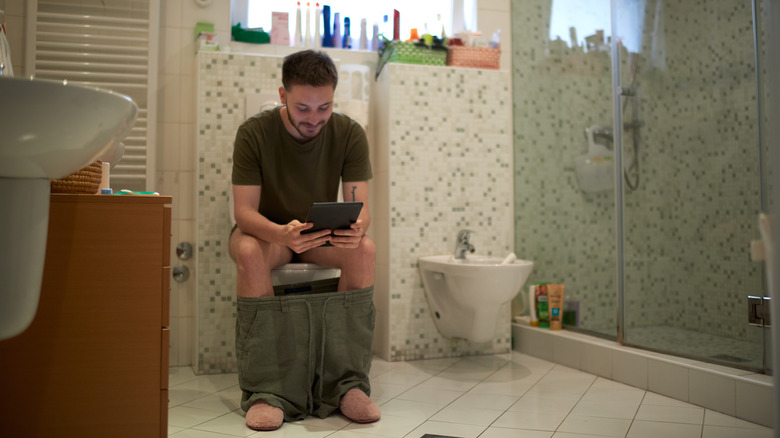 Man pooping on toilet