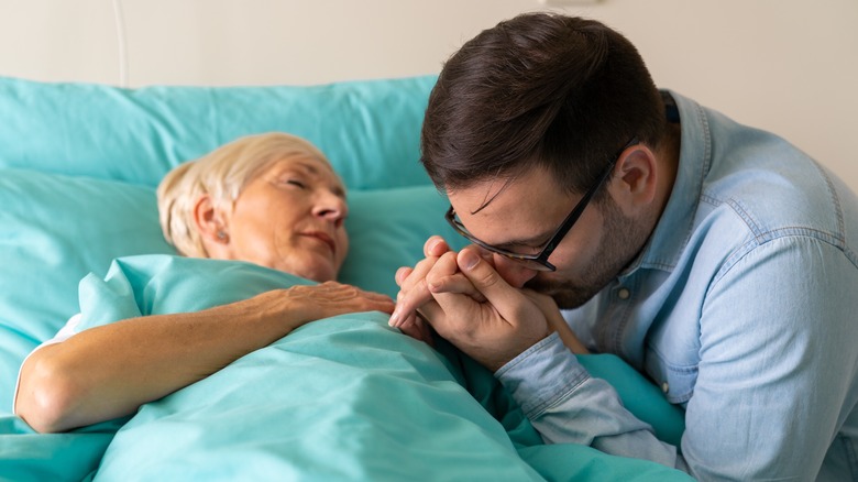 son comforting his dying mother