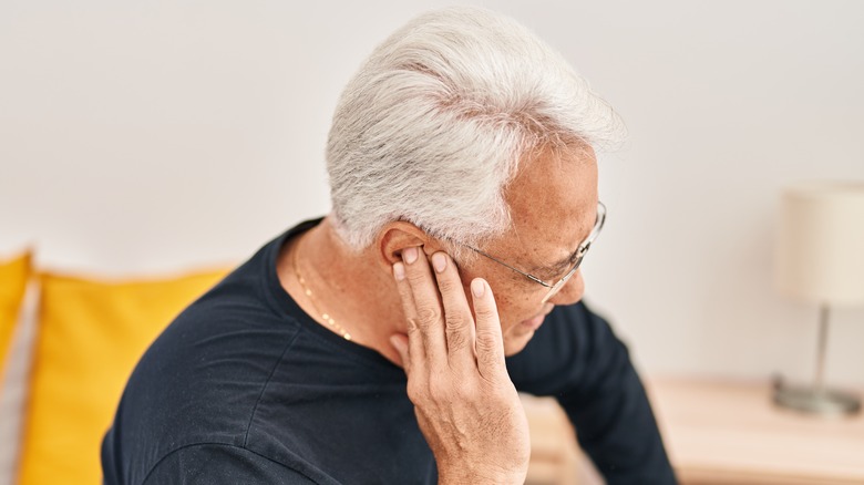 Senior man with ear pain