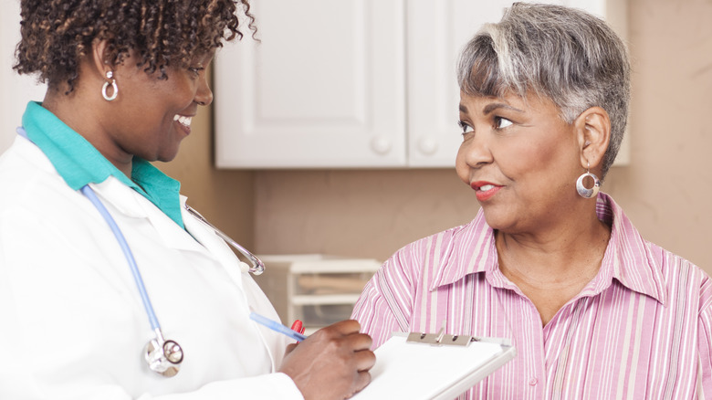 Patient talking to smiling doctor