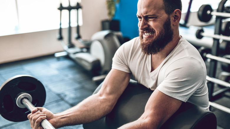 Man lifting barbell with weights