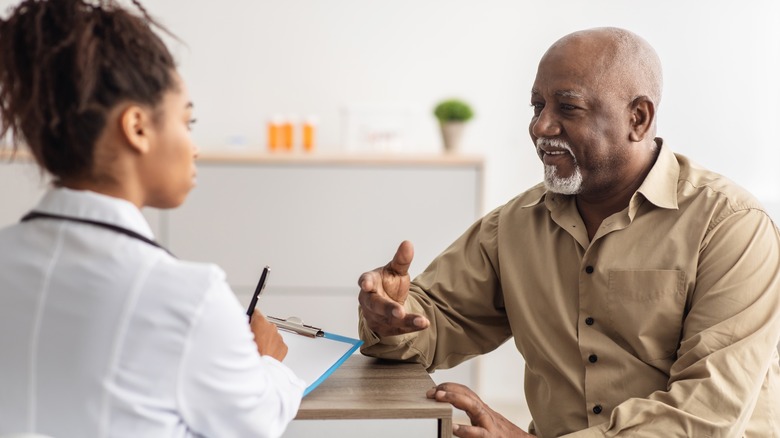 man talking to doctor