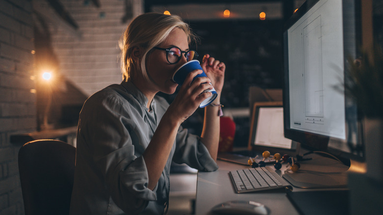 woman drinking coffee at night