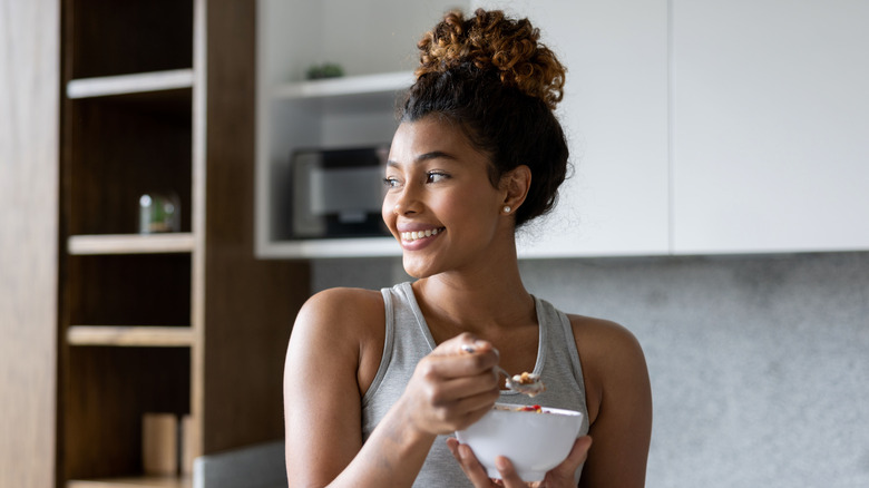 woman eating a bowl of cereal