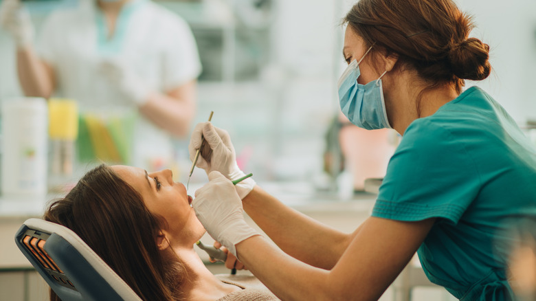 Dentist examining mouth