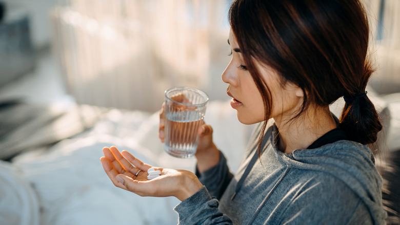 woman taking medicine for her diarrhea