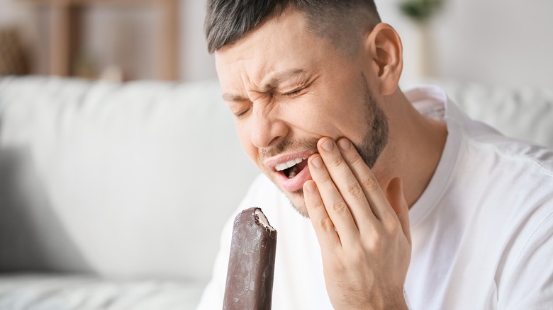 man in pain eating ice cream