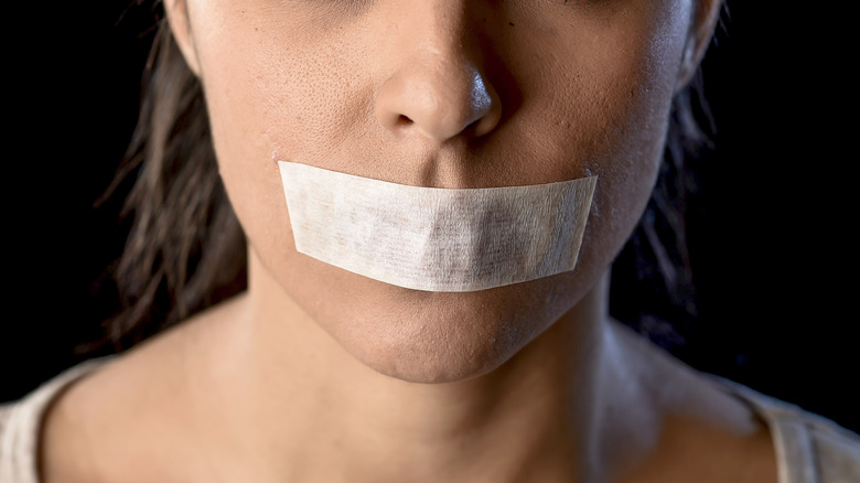 woman with mouth taped shut