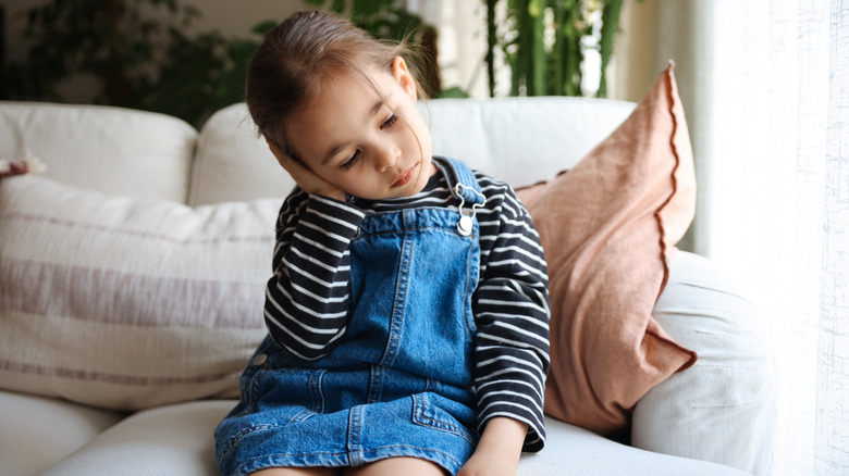 Child holding ear