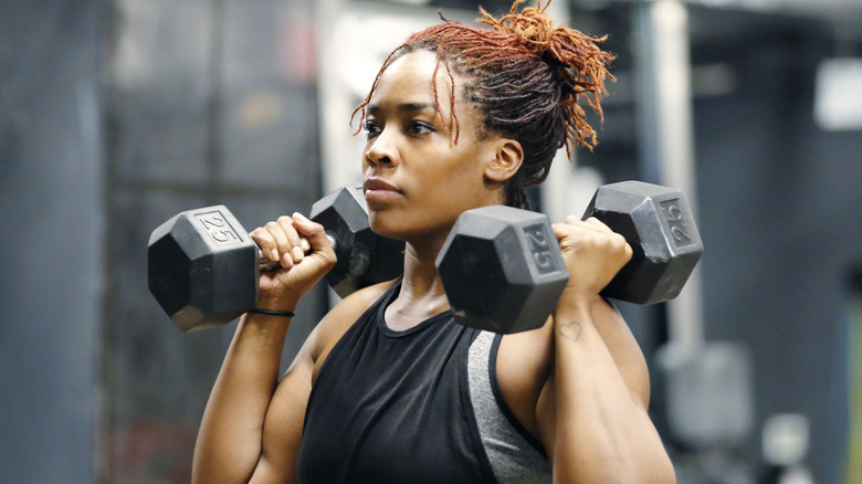 Woman lifting weights in the gym