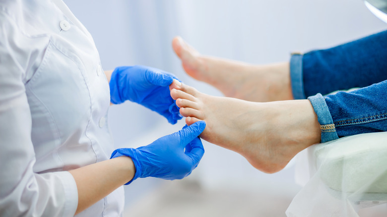 podiatrist examining feet