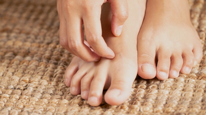 woman scratching her feet