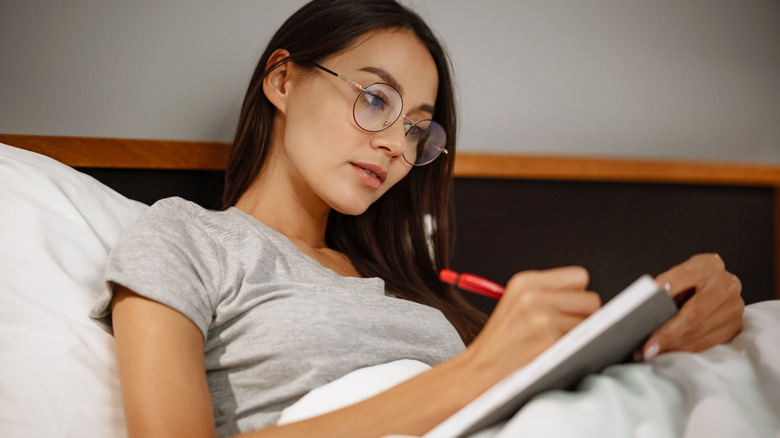 woman writing in a journal