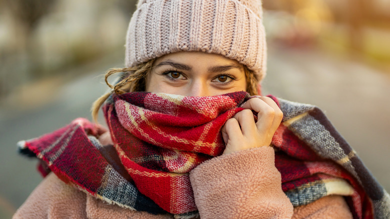 woman wearing scarf over mouth and nose