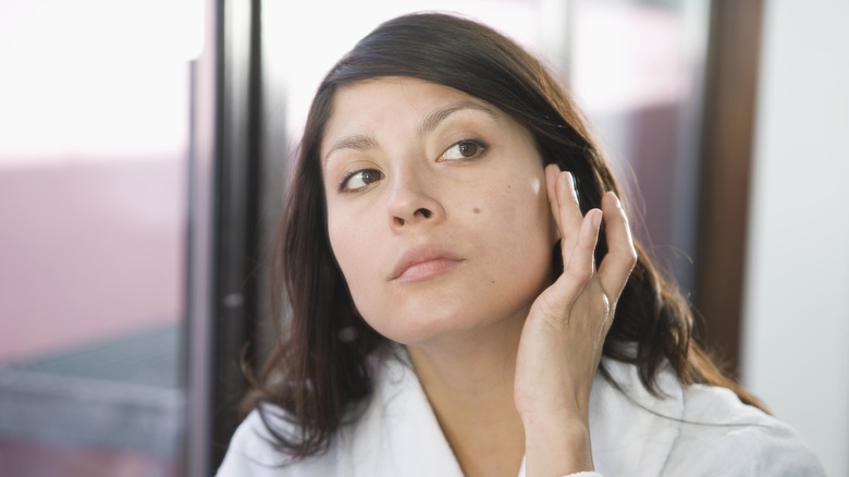 Woman checking out mole