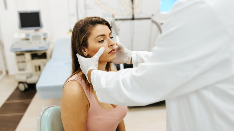 Woman at doctor getting sinuses checked