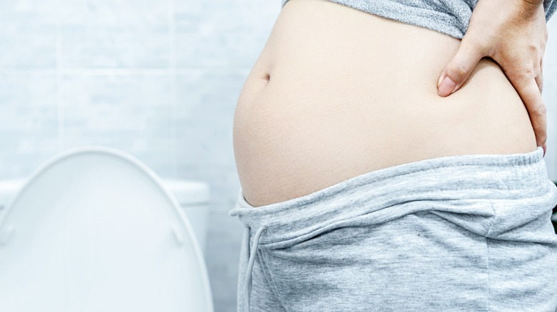 Bloated woman's belly from constipation