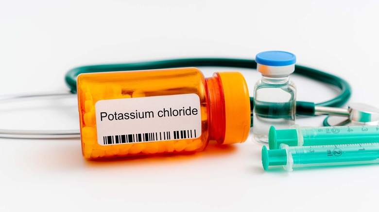 bottle of potassium pills with heart monitor