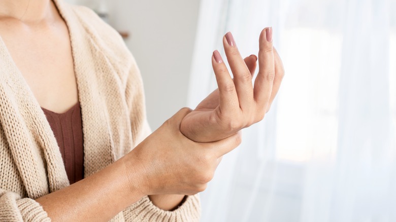 woman holding wrist