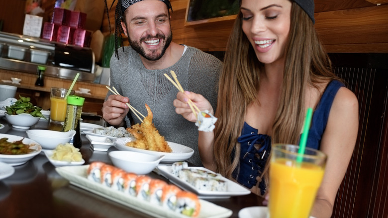 Woman and man eating sushi