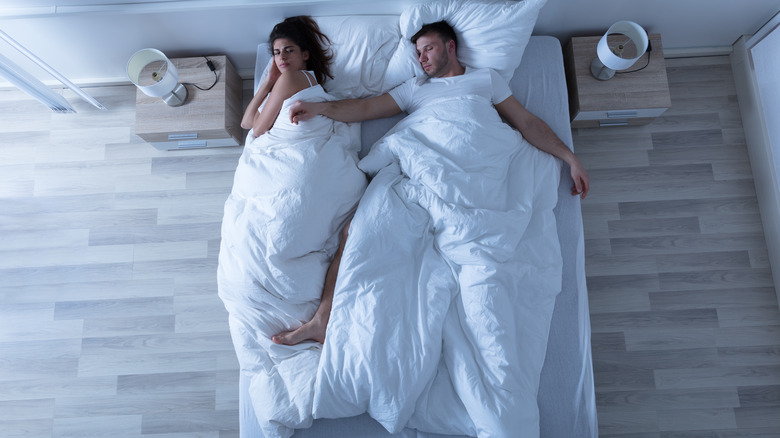 High-angle shot of couple in bed
