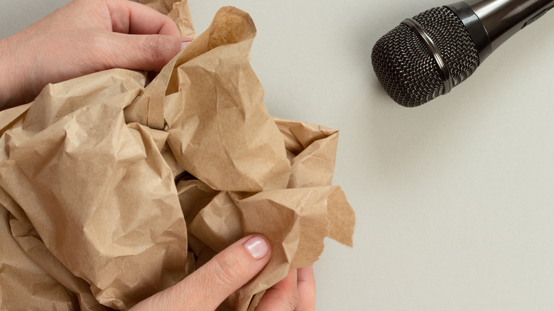 person crinkling a paper bag