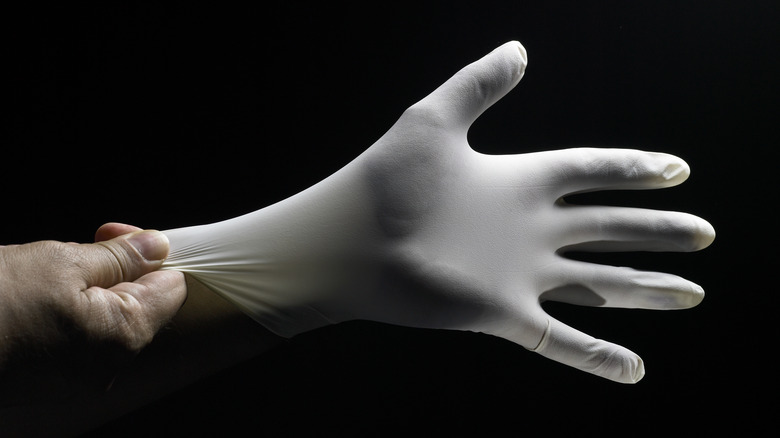 person wearing rubber glove