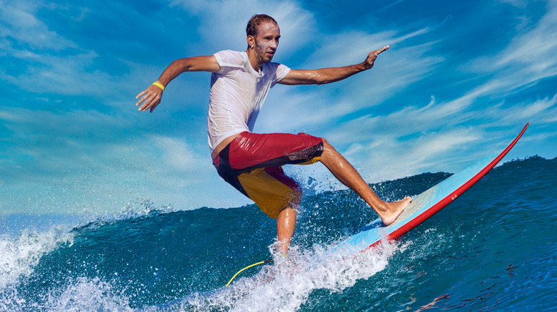 Man in a white t-shirt surfing