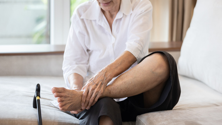 Older person on bed examining food