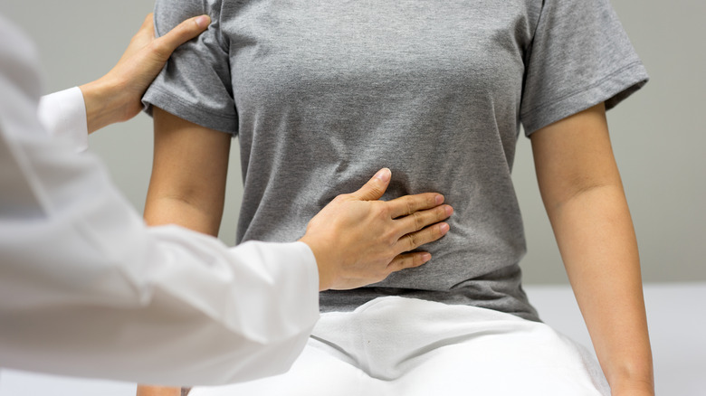 doctor examining stomach